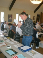 Steve Foster looking at auction items at April meeting